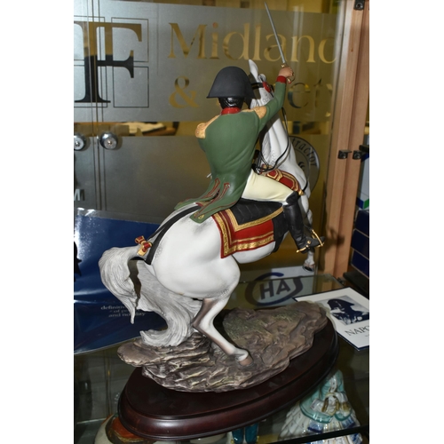 632 - A FRANKLIN MINT PORCELAIN FIGURE 'NAPOLEON', designed by Ronald Van Ruyckevelt, mounted on a wooden ... 