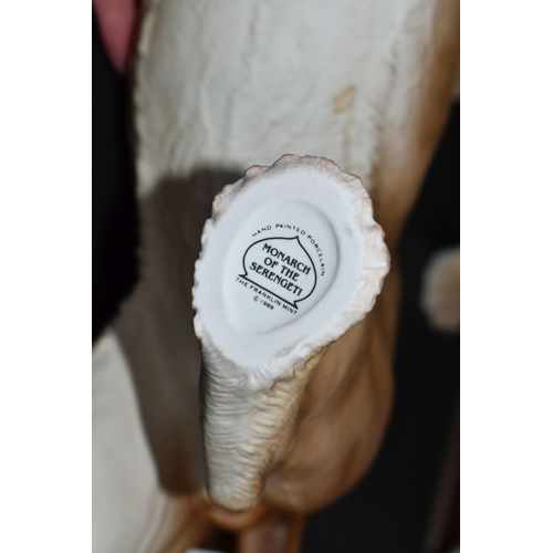 680 - TWO FRANKLIN MINT HAND PAINTED PORCELAIN BIG CATS, comprising a Lion 'Monarch of the Serengeti' appr... 