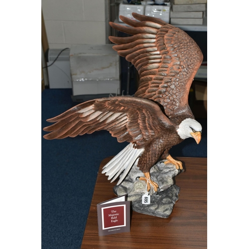 695 - A BOXED FRANKLIN MINT 'THE MAJESTIC BALD EAGLE' FIGURE by Ronald Van Ruyckevelt, depicting a bald ea... 