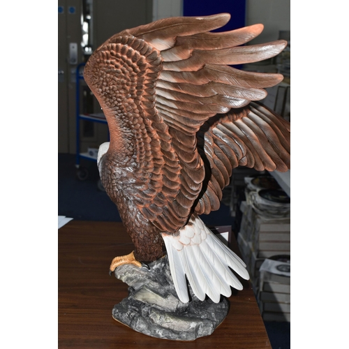695 - A BOXED FRANKLIN MINT 'THE MAJESTIC BALD EAGLE' FIGURE by Ronald Van Ruyckevelt, depicting a bald ea... 