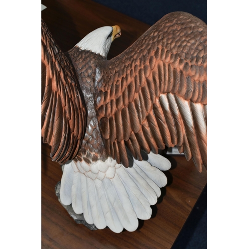 695 - A BOXED FRANKLIN MINT 'THE MAJESTIC BALD EAGLE' FIGURE by Ronald Van Ruyckevelt, depicting a bald ea... 