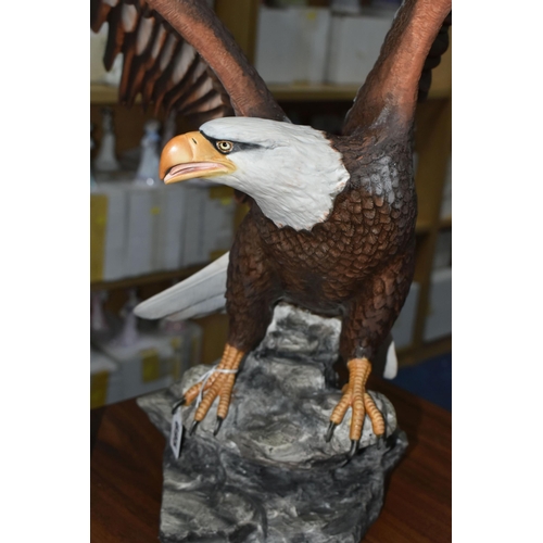 695 - A BOXED FRANKLIN MINT 'THE MAJESTIC BALD EAGLE' FIGURE by Ronald Van Ruyckevelt, depicting a bald ea... 