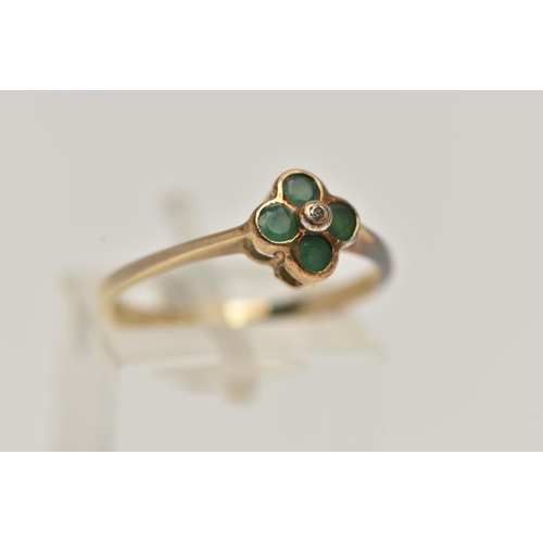 103 - A 9CT GOLD QUATREFOIL EMERALD RING, four circular cut emeralds in a semi bezel setting, accented wit... 