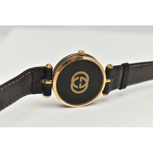 15 - A VINTAGE LADYS GOLD PLATED QUARTZ GUCCI WRISTWATCH, round black dial signed Gucci, case width appro... 