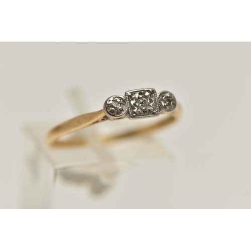 56 - A YELLOW AND WHITE METAL THREE STONE DIAMOND RING, three small single cut diamonds illusion set in a... 