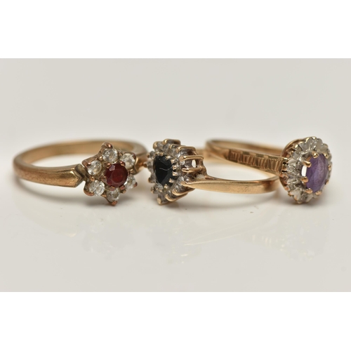 66 - THREE 9CT GOLD GEM SET RINGS, to include a heart shape sapphire and cubic zirconia cluster ring (one... 