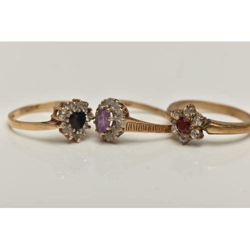 66 - THREE 9CT GOLD GEM SET RINGS, to include a heart shape sapphire and cubic zirconia cluster ring (one... 