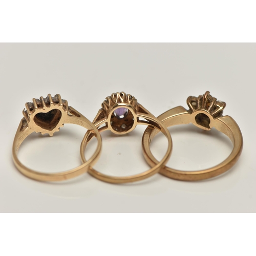 66 - THREE 9CT GOLD GEM SET RINGS, to include a heart shape sapphire and cubic zirconia cluster ring (one... 