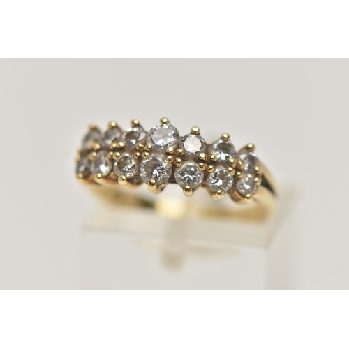 74 - AN 18CT GOLD DIAMOND RING, designed with two rows of graduated round brilliant cut diamonds, shared ... 