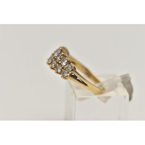 74 - AN 18CT GOLD DIAMOND RING, designed with two rows of graduated round brilliant cut diamonds, shared ... 