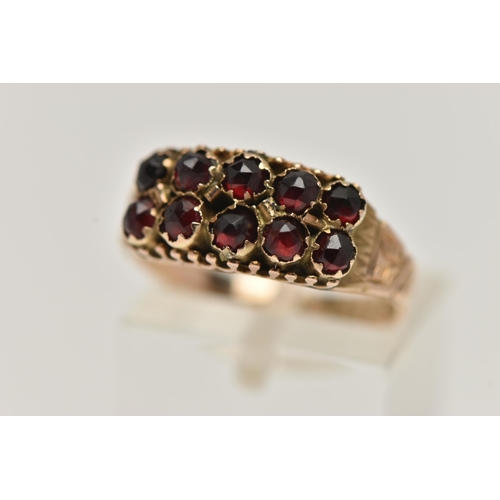 78 - A LATE VICTORIAN 9CT GOLD GARNET RING, designed with two rows of five rose cut garnets, to a texture... 