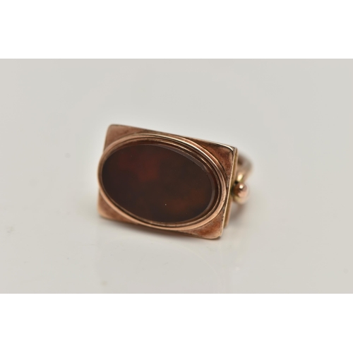 82 - A LATE VICTORIAN 9CT GOLD FOB, of a rectangular form set with an oval polished carnelian inlay, arch... 