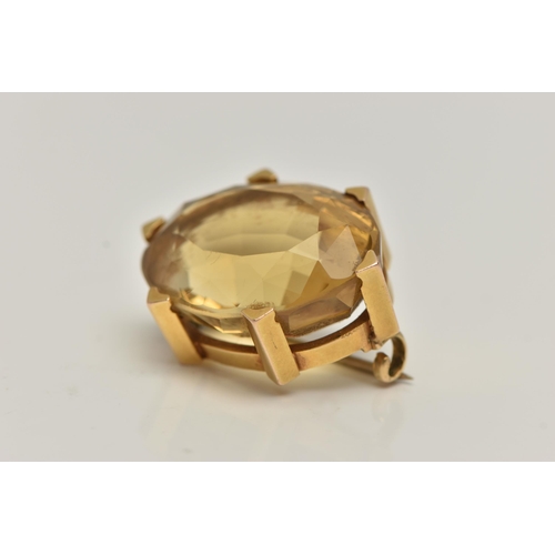 90 - A LATE VICTORIAN 15CT GOLD AND CITRINE BROOCH, oval cut citrine, prong set with six triangular form ... 