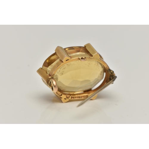 90 - A LATE VICTORIAN 15CT GOLD AND CITRINE BROOCH, oval cut citrine, prong set with six triangular form ... 