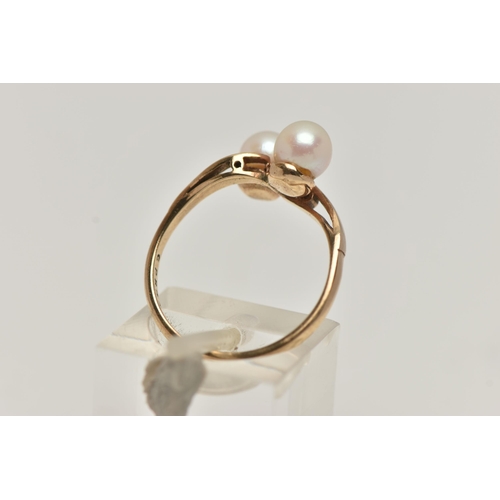 97 - A CULTURED PEARL RING, two cultured pearls set in a yellow metal bypass mount, unmarked, ring size N... 