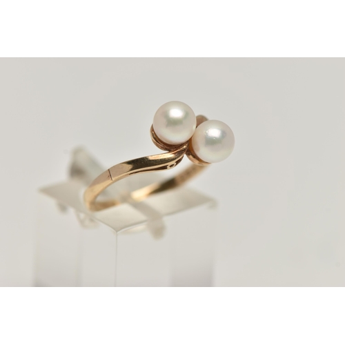 97 - A CULTURED PEARL RING, two cultured pearls set in a yellow metal bypass mount, unmarked, ring size N... 