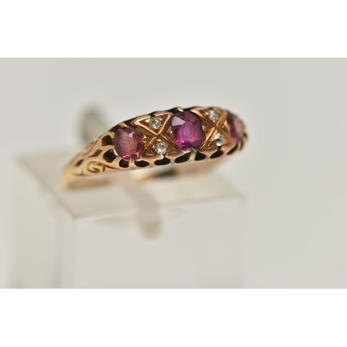 99 - A YELLOW METAL GEM SET RING, a centrally set oval cut ruby, four old cut diamonds, two oval cut pink... 