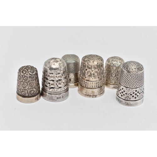 123 - SIX THIMBLES, to include four with full silver hallmarks, approximate gross weight 18.4 grams, one s... 