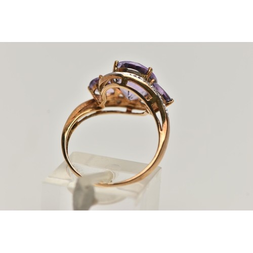 143 - AN AMETHYST AND DIAMOND DRESS RING, principle oval cut amethyst with two additional pear cut amethys... 