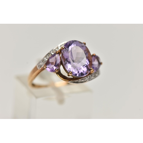 143 - AN AMETHYST AND DIAMOND DRESS RING, principle oval cut amethyst with two additional pear cut amethys... 