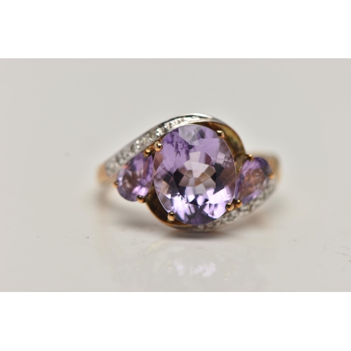 143 - AN AMETHYST AND DIAMOND DRESS RING, principle oval cut amethyst with two additional pear cut amethys... 