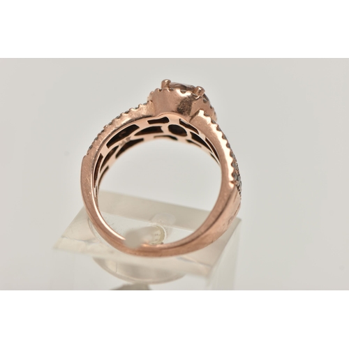 146 - A 14CT GOLD 'LE VIAN' DRESS RING, oval cut morganite, prong set in rose gold with a halo of colourle... 