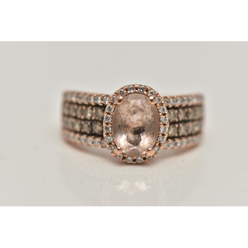 146 - A 14CT GOLD 'LE VIAN' DRESS RING, oval cut morganite, prong set in rose gold with a halo of colourle... 