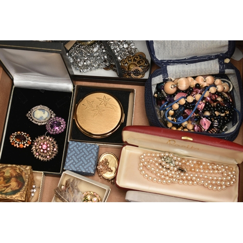 206 - TWO BOXES OF COSTUME JEWELLERY, to include a cream jewellery box, an old First Aid tin box containin... 