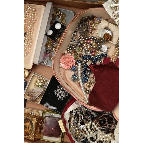 206 - TWO BOXES OF COSTUME JEWELLERY, to include a cream jewellery box, an old First Aid tin box containin... 
