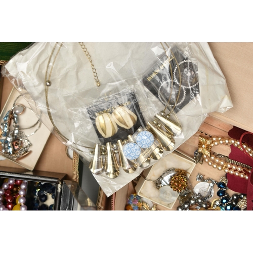206 - TWO BOXES OF COSTUME JEWELLERY, to include a cream jewellery box, an old First Aid tin box containin... 