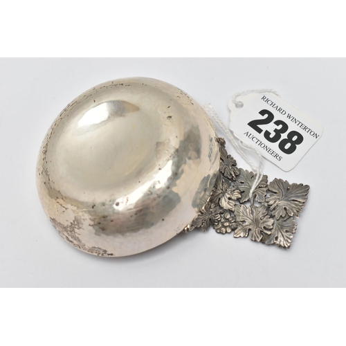 238 - AN ELIZABETH II HECTOR MILLER SILVER WINE TASTER, planished bowl with cast and pierced fruiting vine... 