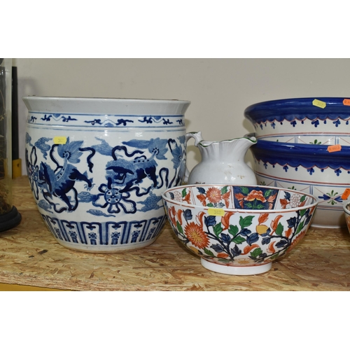 342 - A GROUP OF EIGHT ORIENTAL STYLE PLANTERS AND BOWLS, comprising a large blue and white planter decora... 