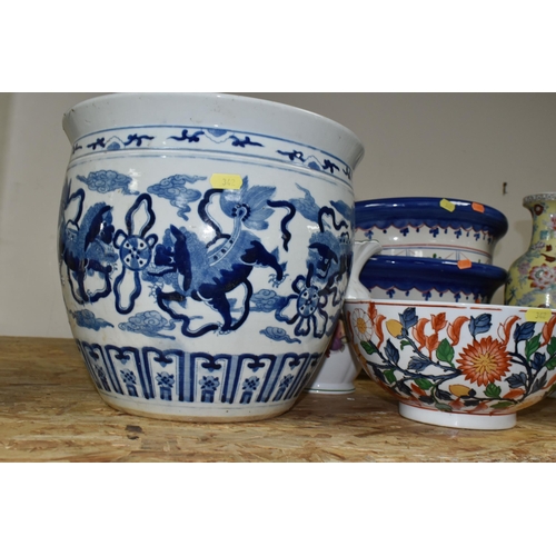 342 - A GROUP OF EIGHT ORIENTAL STYLE PLANTERS AND BOWLS, comprising a large blue and white planter decora... 