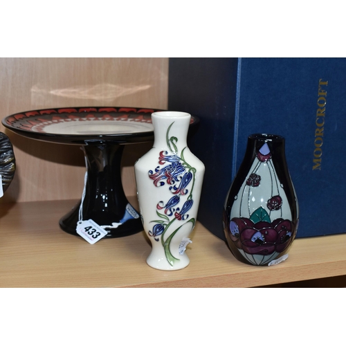 433 - THREE PIECES OF MOORCROFT POTTERY, comprising a boxed Alice in Wonderland collection cake stand, tub... 