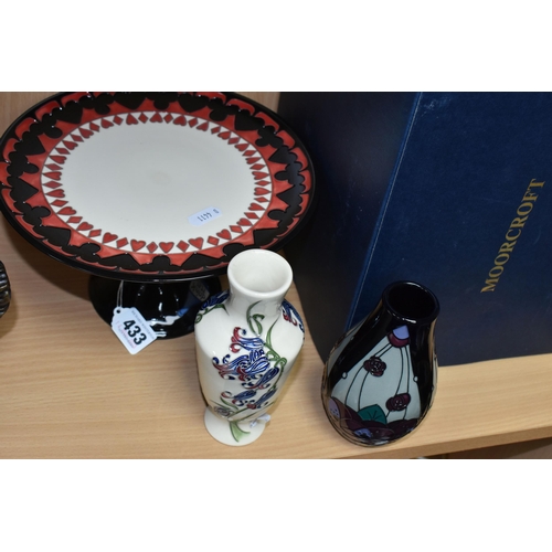 433 - THREE PIECES OF MOORCROFT POTTERY, comprising a boxed Alice in Wonderland collection cake stand, tub... 