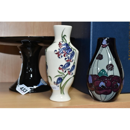 433 - THREE PIECES OF MOORCROFT POTTERY, comprising a boxed Alice in Wonderland collection cake stand, tub... 