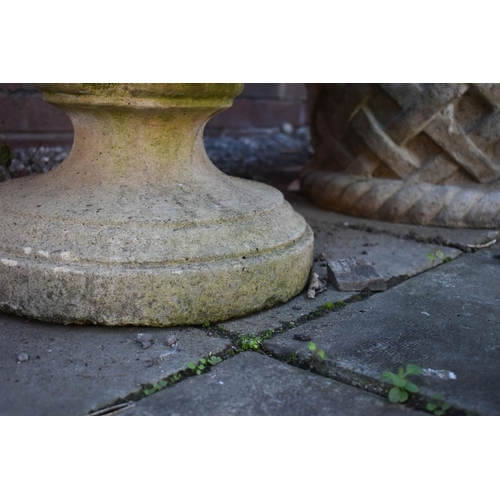 1032 - A WEATHERED CIRCULAR COMPOSITE GARDEN URN, on a seperate plinth base, diamater 54cm x height 47cm (c... 