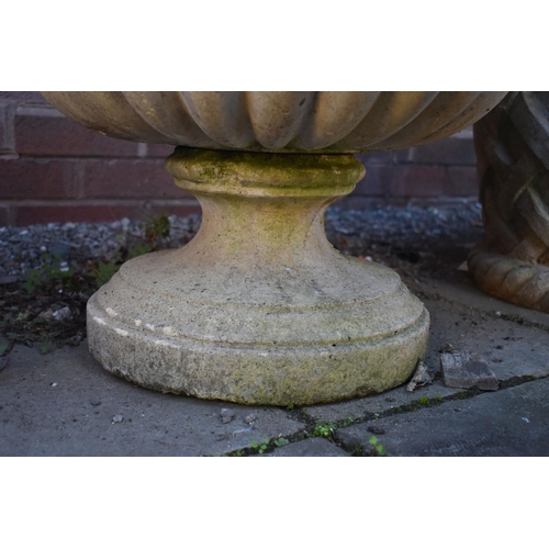 1032 - A WEATHERED CIRCULAR COMPOSITE GARDEN URN, on a seperate plinth base, diamater 54cm x height 47cm (c... 