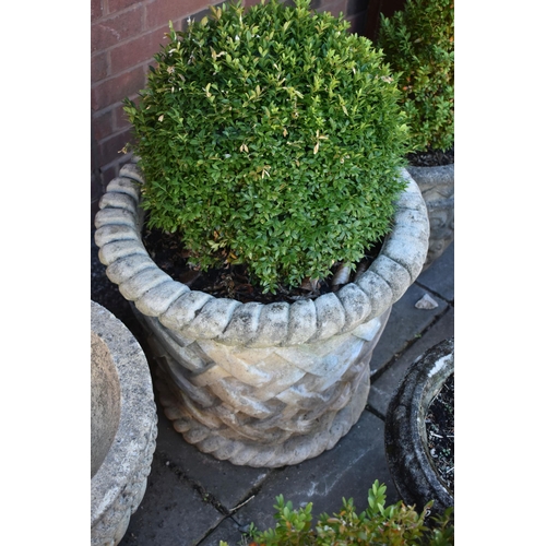 1033 - A LARGE COMPOSITE CYLINDRICAL TAPERED GARDEN PLANTER, with rope effect rims, and lattice style detai... 