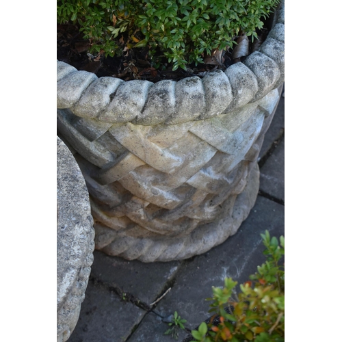 1033 - A LARGE COMPOSITE CYLINDRICAL TAPERED GARDEN PLANTER, with rope effect rims, and lattice style detai... 