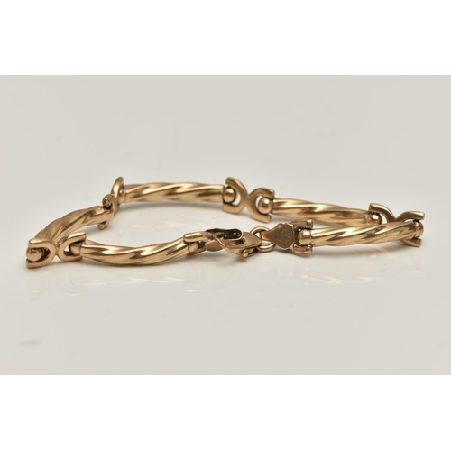 13 - A 9CT GOLD FANCY LINK BRACELET, designed as a series of curved textured bars, fitted with a lobster ... 