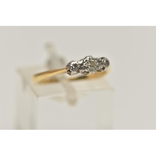 38 - A YELLOW AND WHITE METAL THREE STONE DIAMOND RING, three single cut diamonds each illusion set in a ... 