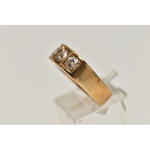 4 - A YELLOW METAL THREE STONE DIAMOND RING, three old cut diamonds, each claw set in a square mount, to... 