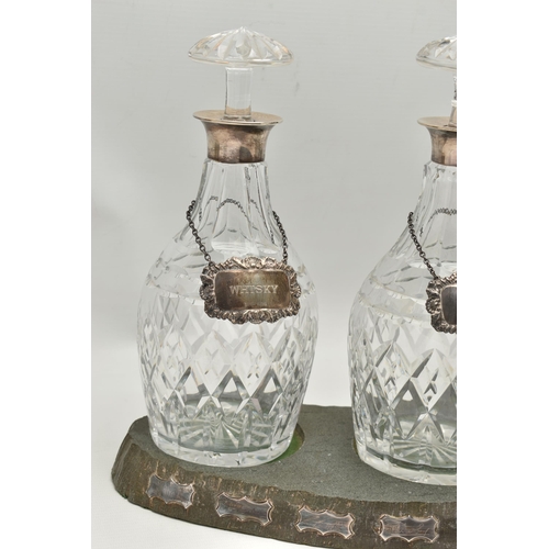 80 - A SET OF THREE ELIZABETH II SILVER MOUNTED CUT GLASS MALLET SHAPED DECANTERS, with mushroom stoppers... 