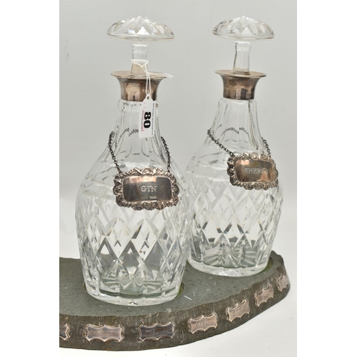 80 - A SET OF THREE ELIZABETH II SILVER MOUNTED CUT GLASS MALLET SHAPED DECANTERS, with mushroom stoppers... 