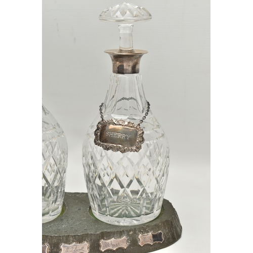 80 - A SET OF THREE ELIZABETH II SILVER MOUNTED CUT GLASS MALLET SHAPED DECANTERS, with mushroom stoppers... 