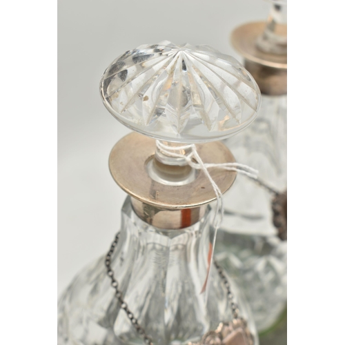 80 - A SET OF THREE ELIZABETH II SILVER MOUNTED CUT GLASS MALLET SHAPED DECANTERS, with mushroom stoppers... 