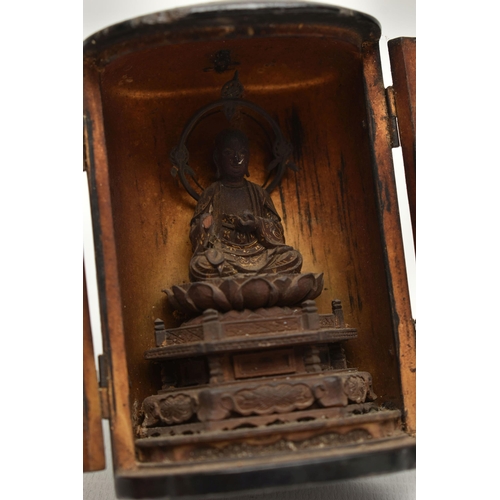 86 - A LATE 19TH CENTURY JAPANESE LACQUER ZUSHI SHRINE, the oval double door cabinet opening to reveal a ... 