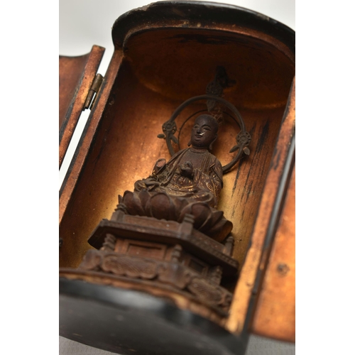 86 - A LATE 19TH CENTURY JAPANESE LACQUER ZUSHI SHRINE, the oval double door cabinet opening to reveal a ... 