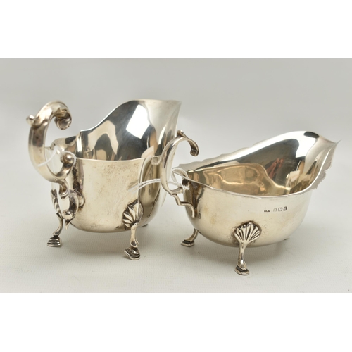 94 - TWO GEORGE VI SILVER SAUCE BOATS, both with wavy rims, C scroll handles and on three cabriole legs w... 